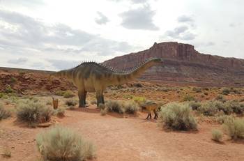 A sauropod and baby stand along the Dinosaur Trail at Moab Giants, Moab, UT.
